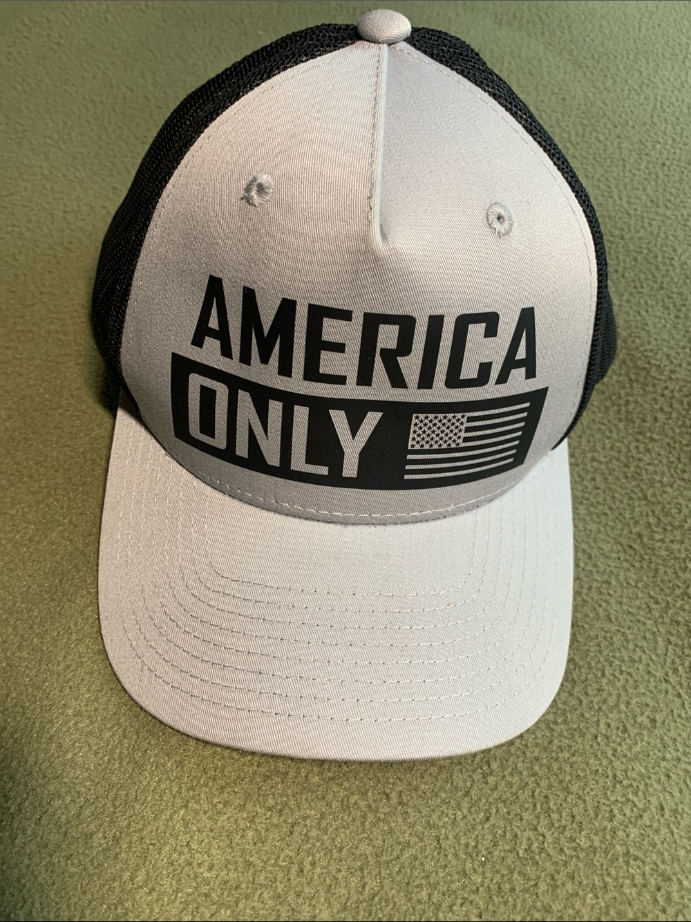 NWOT Decky gray and black America Only truckers hat. Adjustable back strap